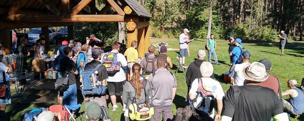 Participants gathering before start of disc golf tournament